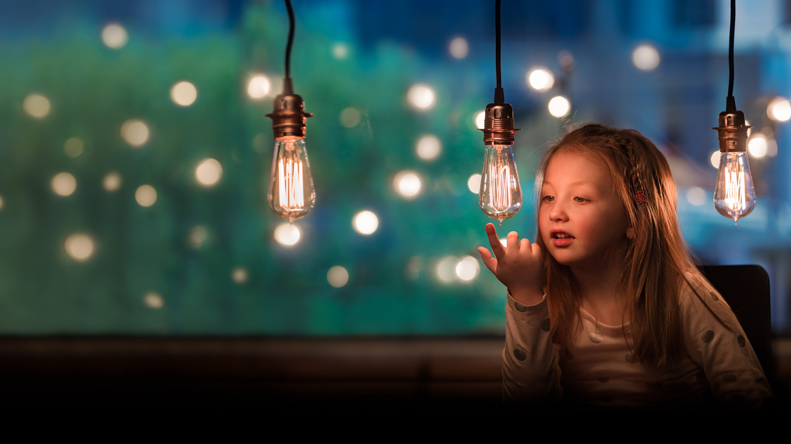 Girl looking at lightbulbs up close