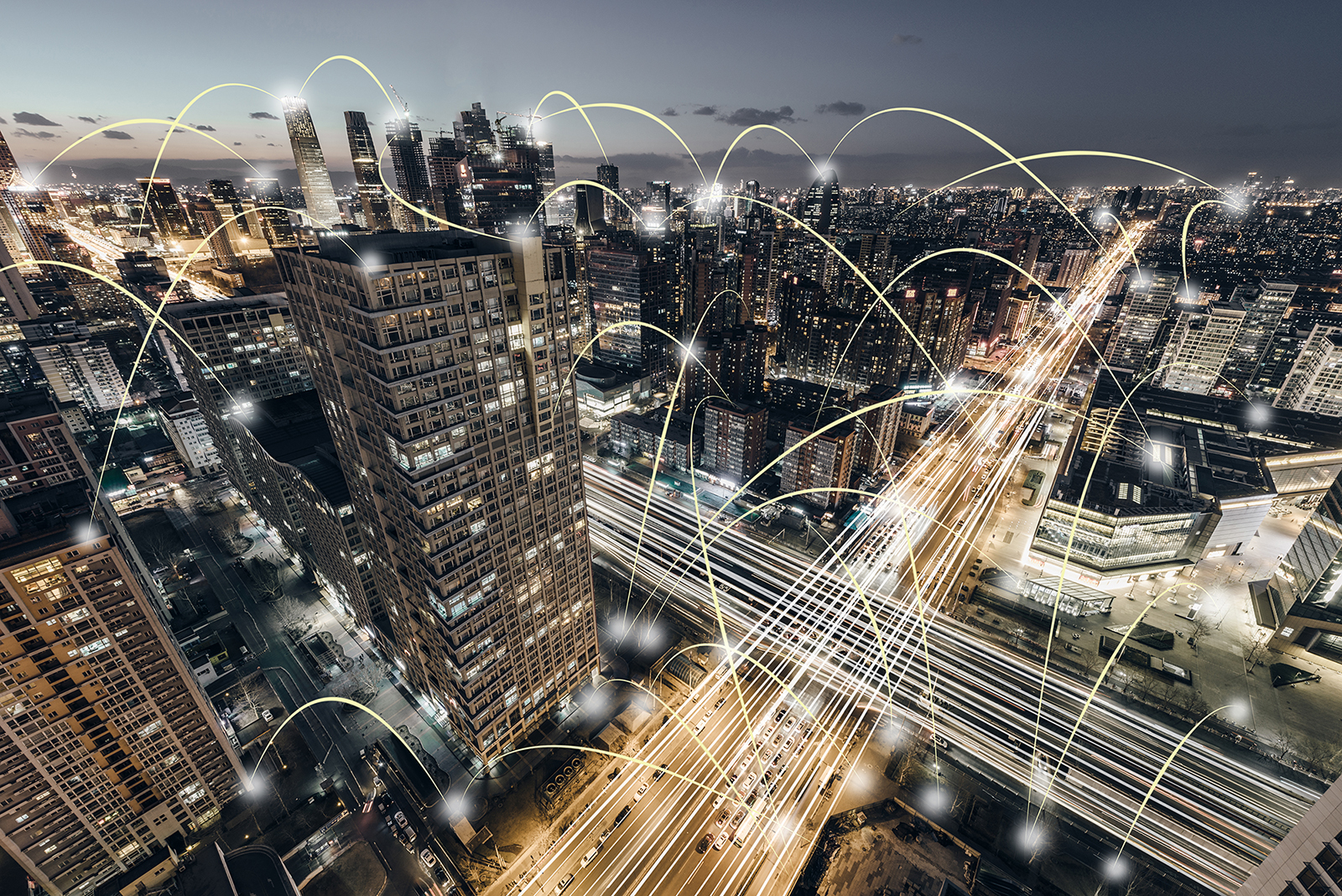 Aerial view of a city at night with a network of lights