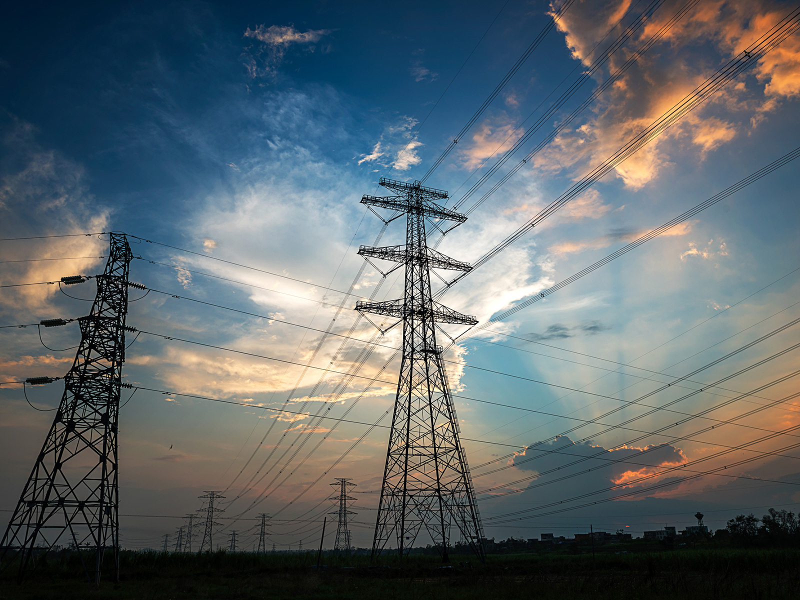 Transmission towers with cloudy sky