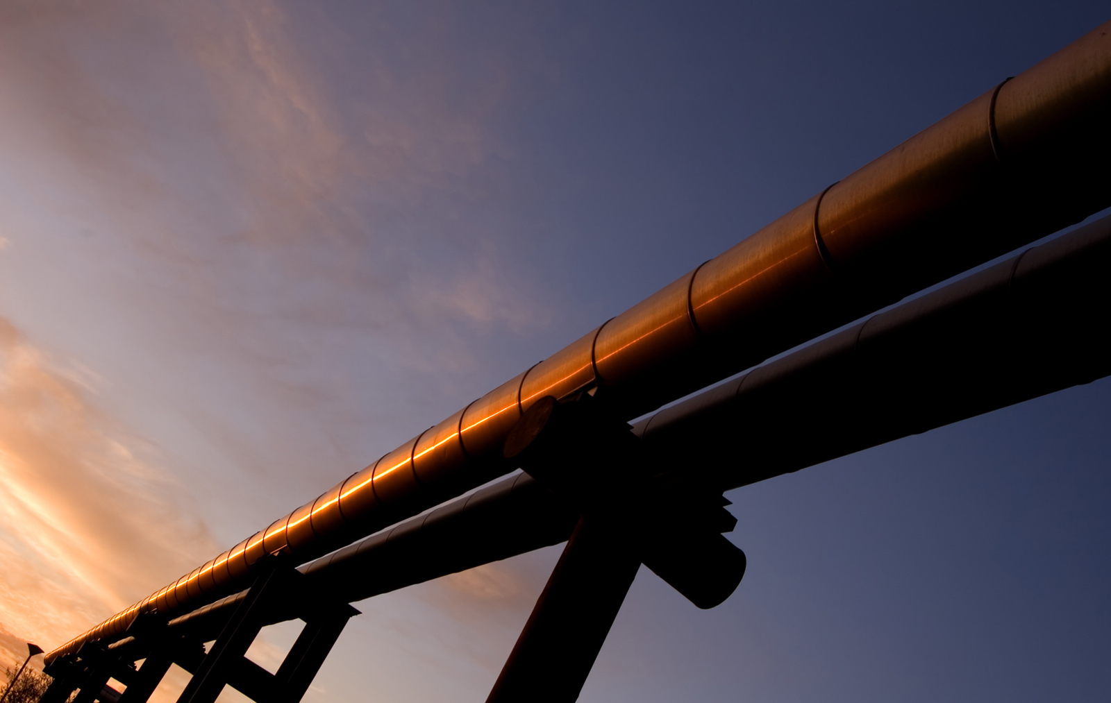 elevated gas pipes against sunset sky