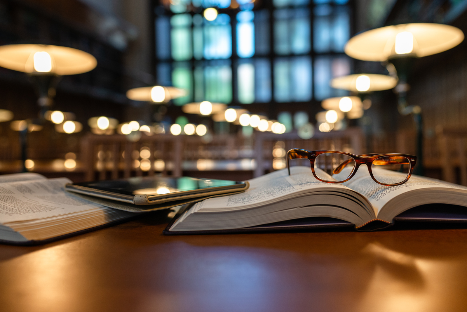 Books and tablet in university library