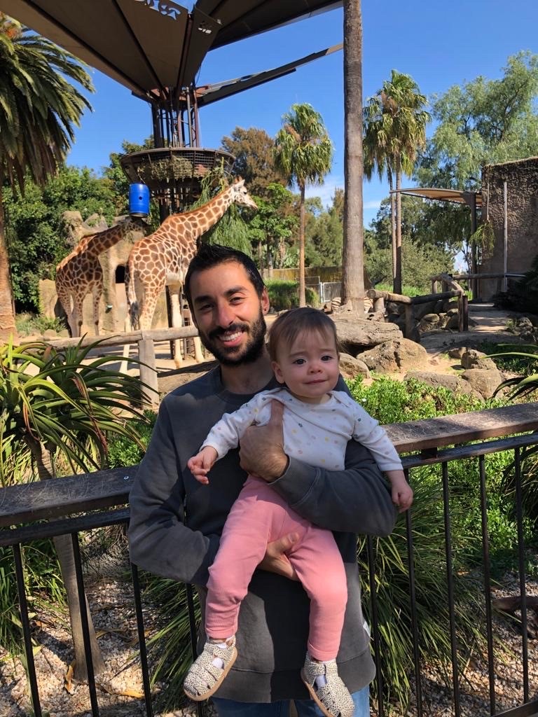 Jess and his daughter visiting giraffes at the zoo