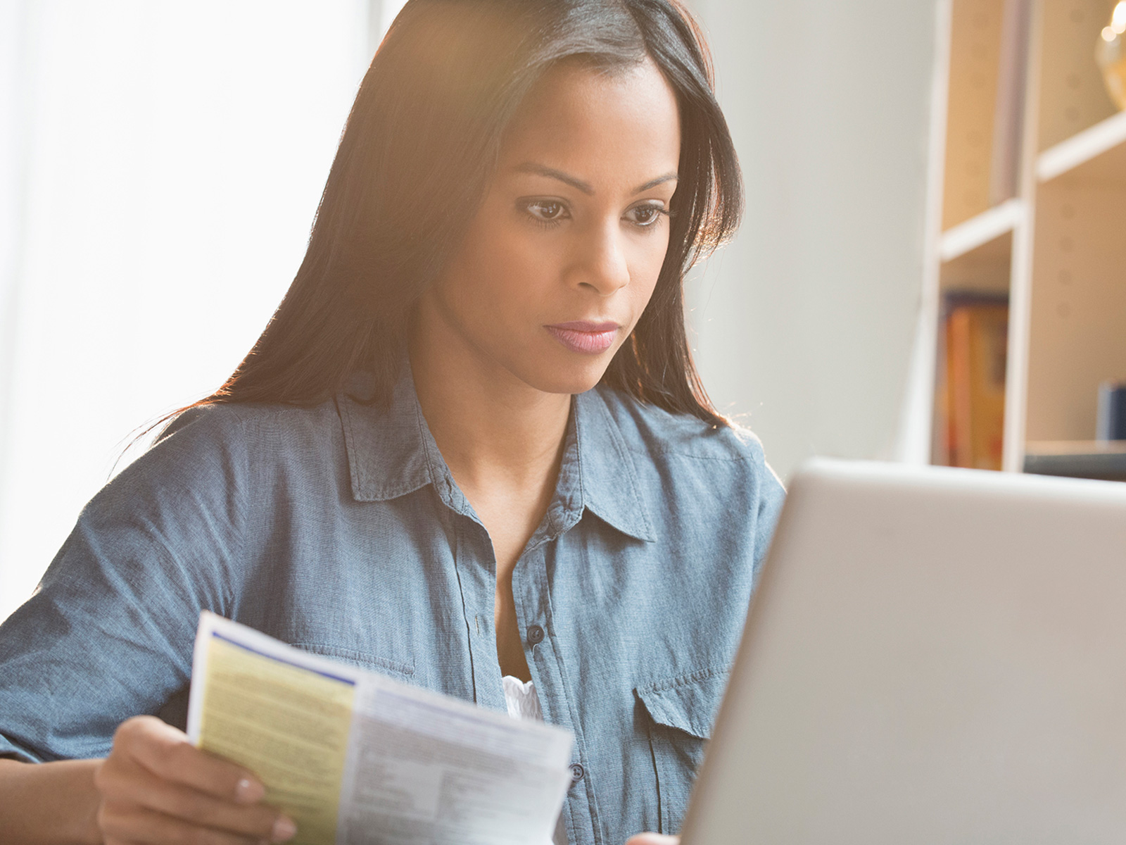 Woman checking her bill and paying online