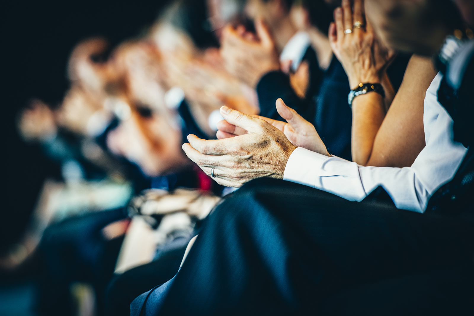 Audience clapping at a business conference