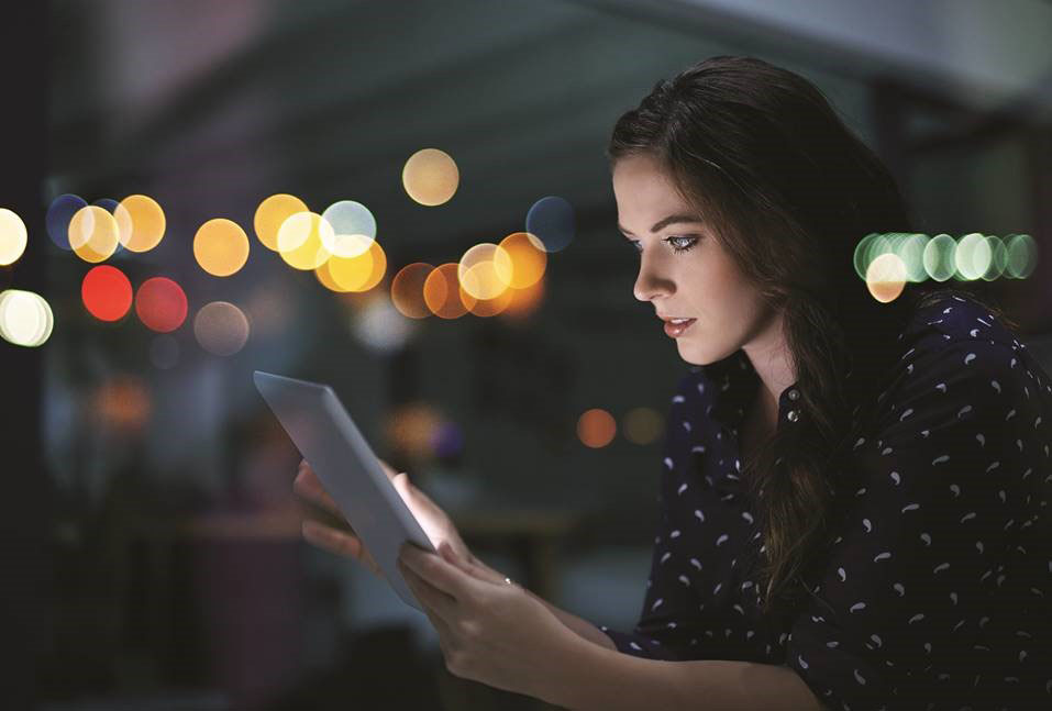 Annual report cover image of woman looking at a tablet
