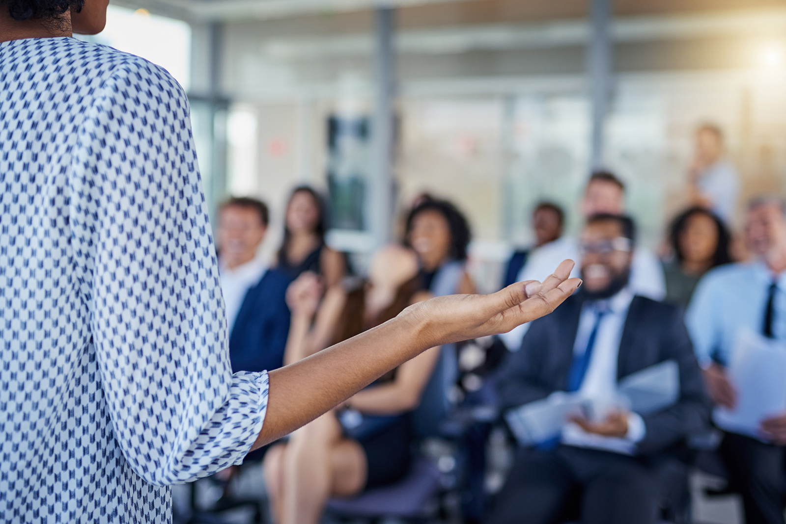 Woman leading education workshop to seated audience