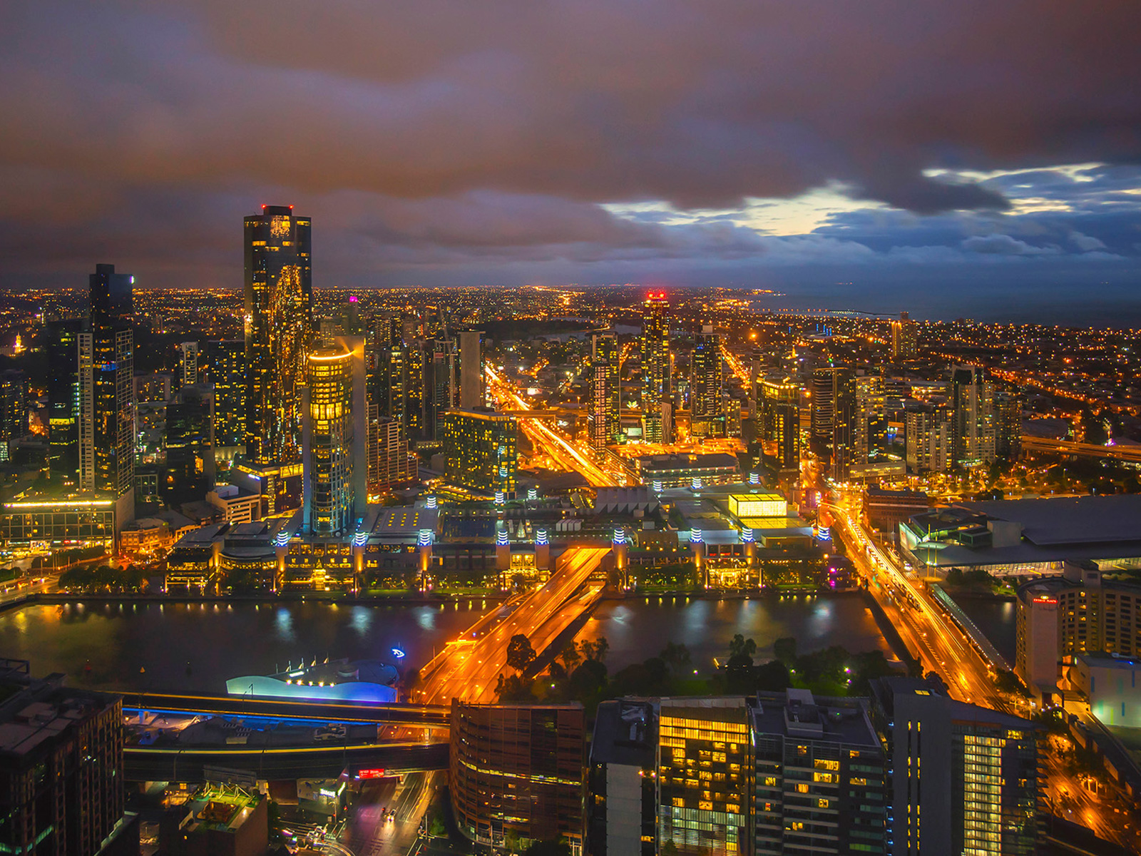 Storm at night above a well lit city