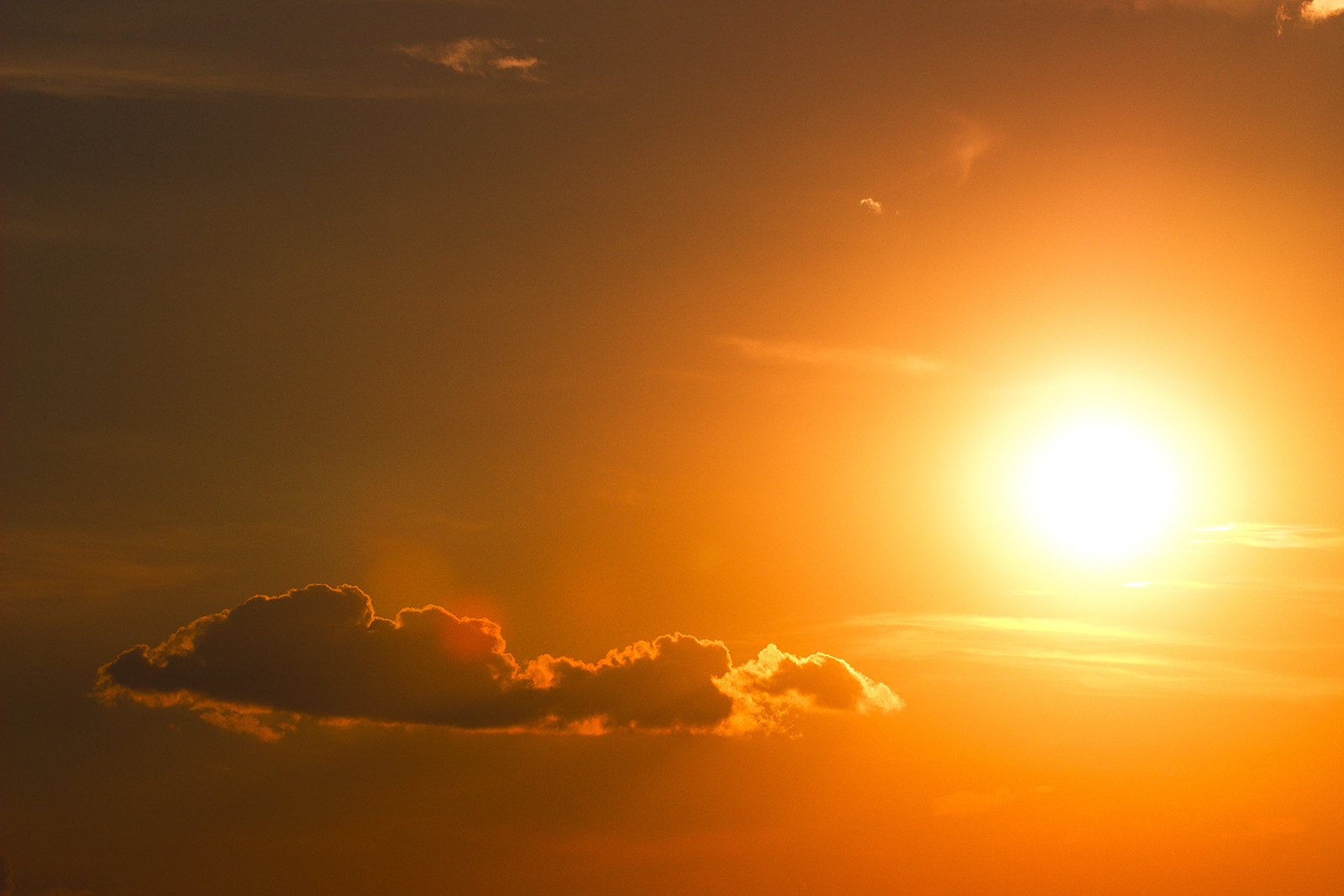 Close up of orange sky and dramatic sun at sunset